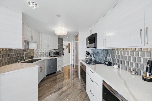 525 S Flagler Dr Unit 16A, West Palm Beach, FL 33401 - kitchen featuring a sink, modern cabinets, backsplash, and stainless steel appliances