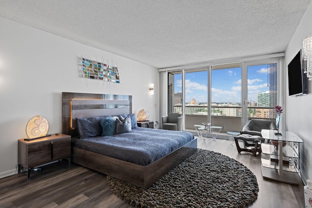 525 S Flagler Dr Unit 16A, West Palm Beach, FL 33401 - bedroom with a textured ceiling, access to exterior, and wood finished floors