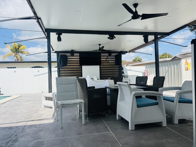 4730 W 8th Pl, Hialeah, FL 33012 - view of patio featuring ceiling fan, fence, a storage unit, an outbuilding, and outdoor dining space