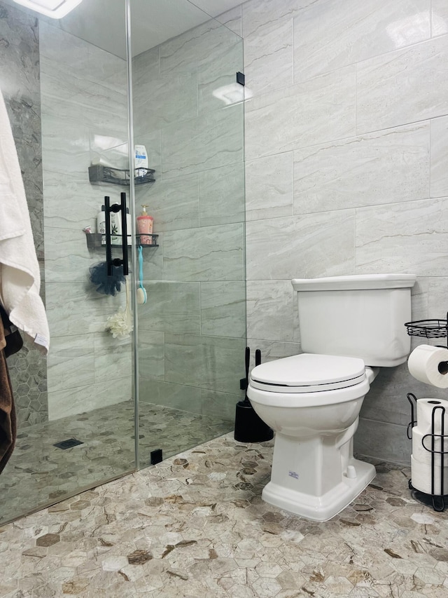 4730 W 8th Pl, Hialeah, FL 33012 - bathroom with tile walls, toilet, and a shower stall