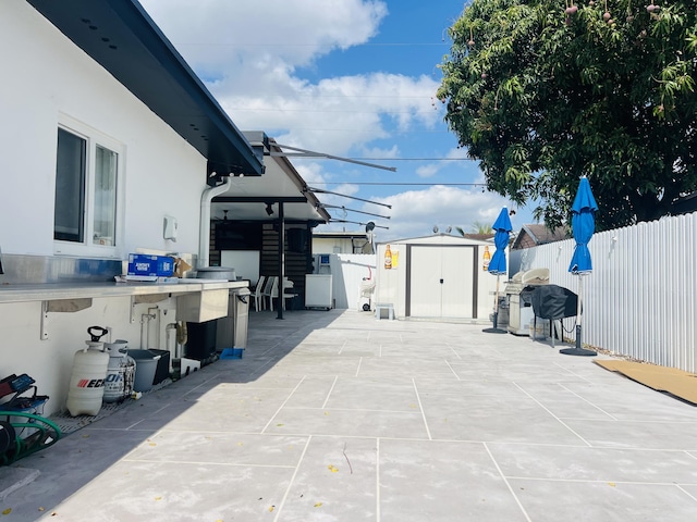 4730 W 8th Pl, Hialeah, FL 33012 - view of patio with an outdoor structure, fence, and a shed