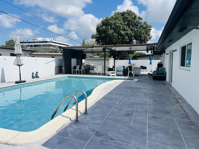 4730 W 8th Pl, Hialeah, FL 33012 - view of swimming pool featuring an outdoor structure, a patio, a fenced backyard, a shed, and a fenced in pool