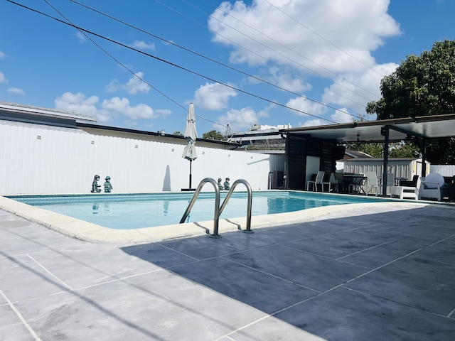 4730 W 8th Pl, Hialeah, FL 33012 - view of pool with an outdoor structure, a patio area, fence, and a shed
