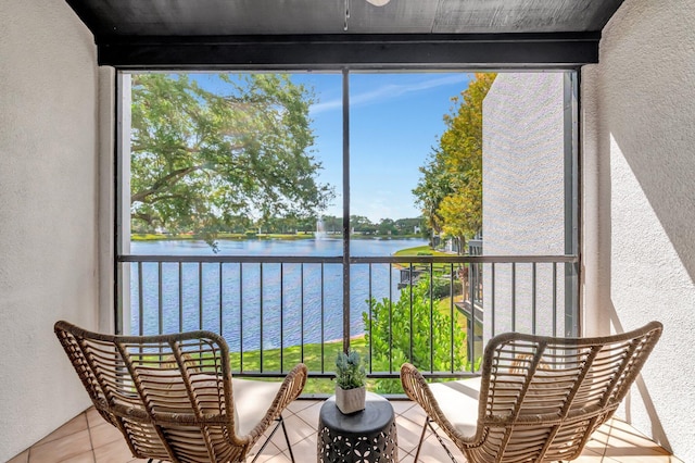 sunroom / solarium featuring a water view