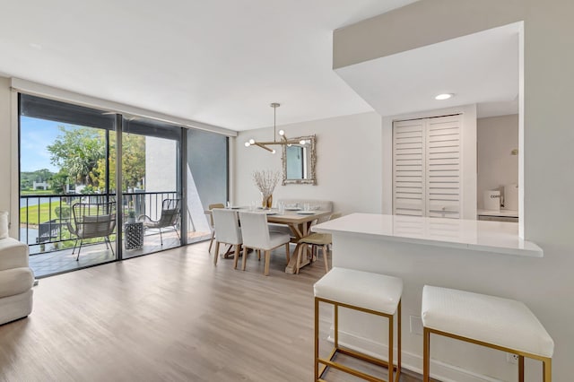 dining room featuring light wood finished floors and a chandelier