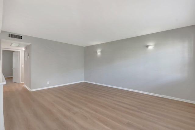 296 Fanshaw H, Boca Raton, FL 33434 - unfurnished room with baseboards and light wood-type flooring