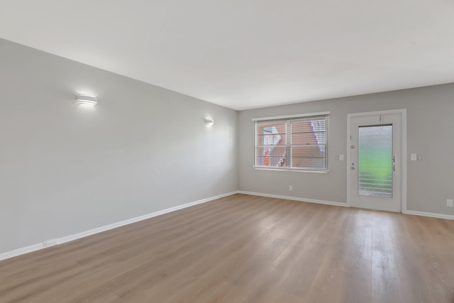 296 Fanshaw H, Boca Raton, FL 33434 - unfurnished living room featuring light wood-type flooring and baseboards
