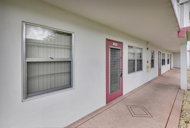 296 Fanshaw H, Boca Raton, FL 33434 - doorway to property with stucco siding, elevator, and a patio area