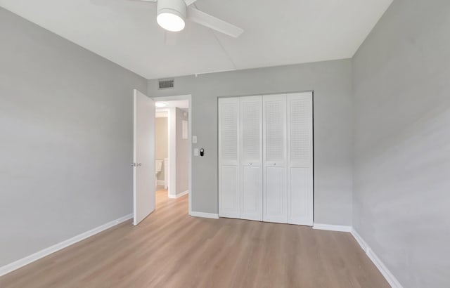296 Fanshaw H, Boca Raton, FL 33434 - unfurnished bedroom featuring light wood finished floors, baseboards, a closet, and a ceiling fan