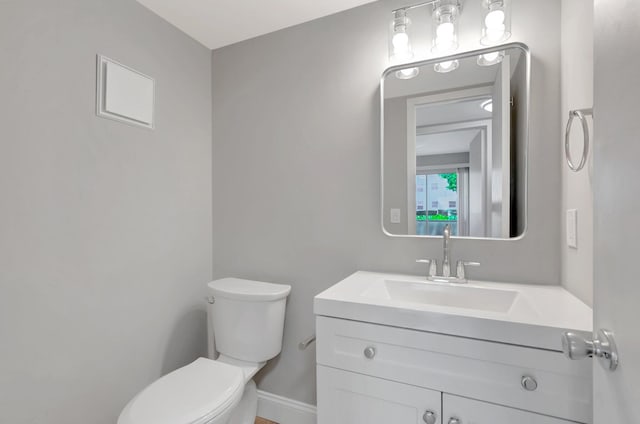 296 Fanshaw H, Boca Raton, FL 33434 - bathroom with toilet, vanity, and baseboards