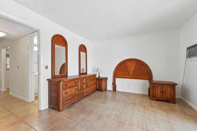 111 Dorchester E Unit 111, West Palm Beach, FL 33417 - bedroom featuring baseboards, a textured ceiling, and light tile patterned floors
