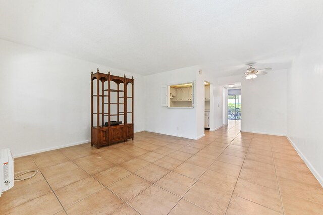 111 Dorchester E Unit 111, West Palm Beach, FL 33417 - empty room featuring light tile patterned floors, baseboards, and ceiling fan