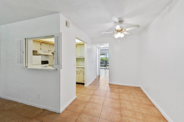 hallway with baseboards and light tile patterned floors