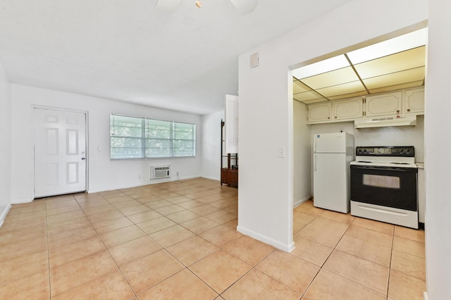 111 Dorchester E Unit 111, West Palm Beach, FL 33417 - kitchen featuring light tile patterned floors, freestanding refrigerator, under cabinet range hood, and electric range