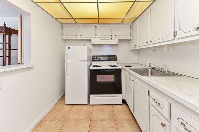kitchen featuring freestanding refrigerator, light countertops, electric range oven, under cabinet range hood, and a sink