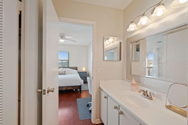 236 Castlewood Dr Unit 301, North Palm Beach, FL 33408 - bathroom featuring ceiling fan, wood finished floors, vanity, and ensuite bathroom