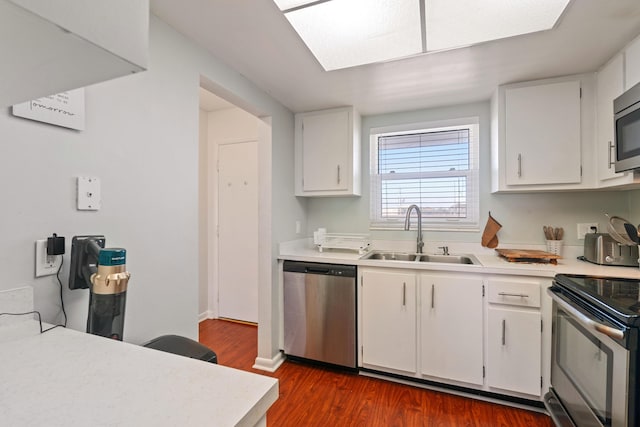 236 Castlewood Dr Unit 301, North Palm Beach, FL 33408 - kitchen with stainless steel appliances, light countertops, dark wood finished floors, and a sink
