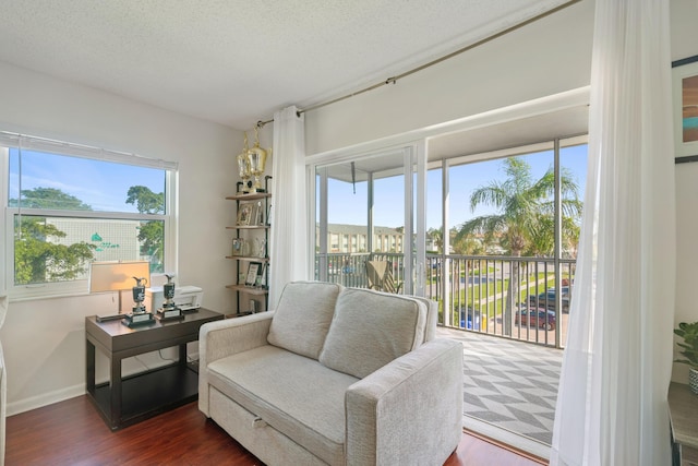 236 Castlewood Dr Unit 301, North Palm Beach, FL 33408 - sitting room featuring baseboards, wood finished floors, and a textured ceiling