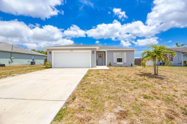 ranch-style home featuring a front lawn, stucco siding, concrete driveway, and an attached garage