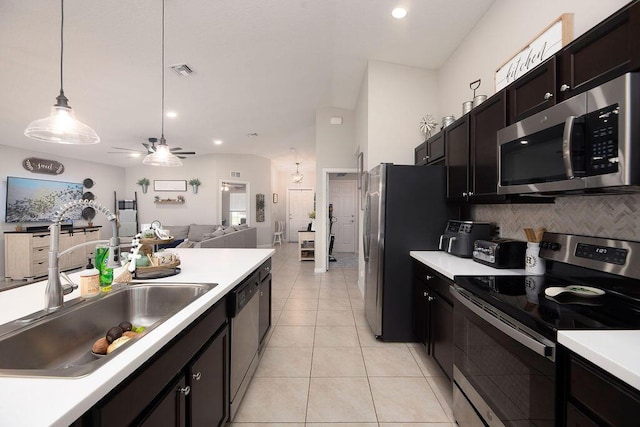 kitchen featuring backsplash, visible vents, appliances with stainless steel finishes, and light countertops