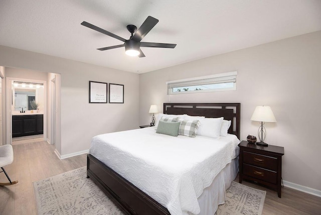bedroom with a ceiling fan, light wood-style flooring, and baseboards