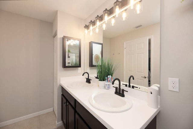 bathroom with tile patterned flooring, a sink, double vanity, and visible vents