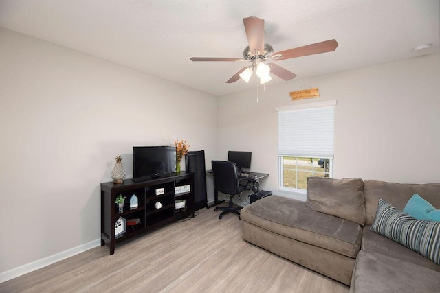 office space featuring ceiling fan, wood finished floors, and baseboards