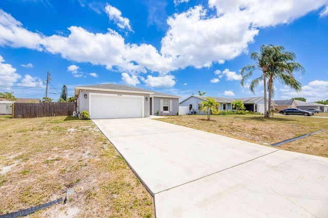 ranch-style house featuring stucco siding, fence, a front yard, concrete driveway, and an attached garage
