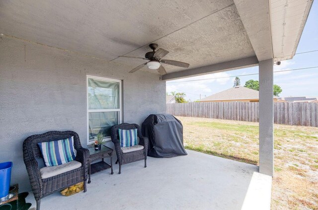 view of patio / terrace with ceiling fan, a fenced backyard, and grilling area