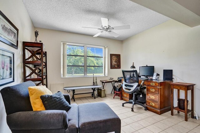 tiled office space with a ceiling fan and a textured ceiling