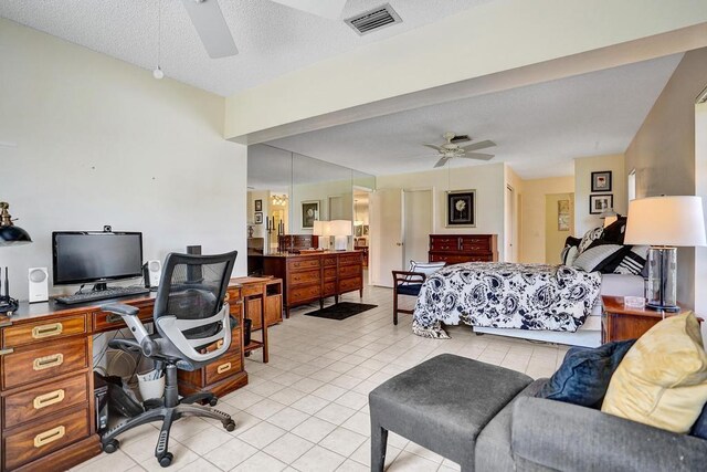 bedroom with light tile patterned flooring, a textured ceiling, visible vents, and ceiling fan