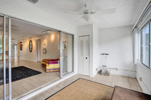 bathroom featuring a ceiling fan, a textured ceiling, visible vents, tile patterned flooring, and rail lighting