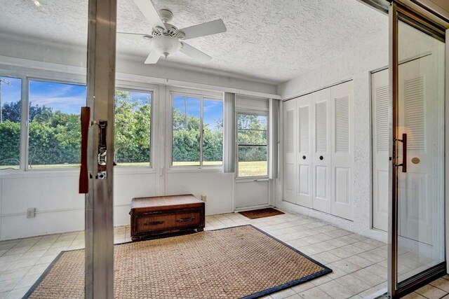 unfurnished sunroom featuring plenty of natural light and french doors