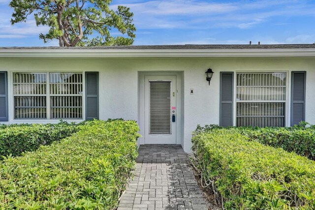 doorway to property with stucco siding