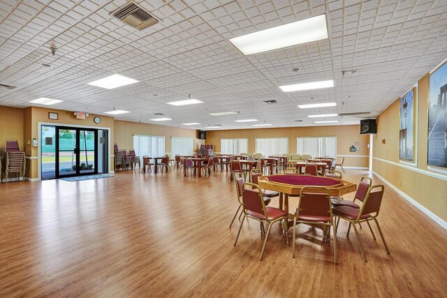 dining space with baseboards, visible vents, a healthy amount of sunlight, and wood finished floors