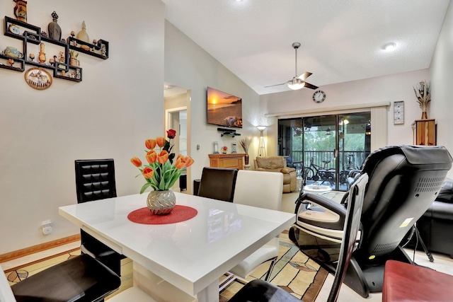 dining space featuring a ceiling fan and vaulted ceiling