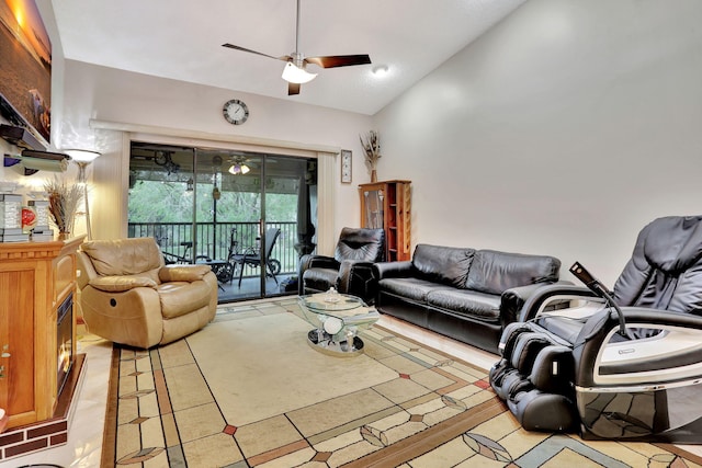living area featuring light tile patterned floors, a ceiling fan, and vaulted ceiling