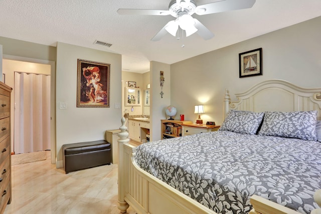 bedroom featuring ceiling fan, visible vents, and connected bathroom