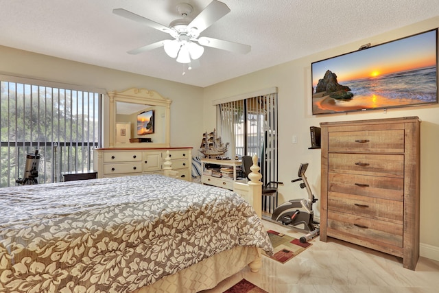 bedroom featuring baseboards, access to outside, and multiple windows