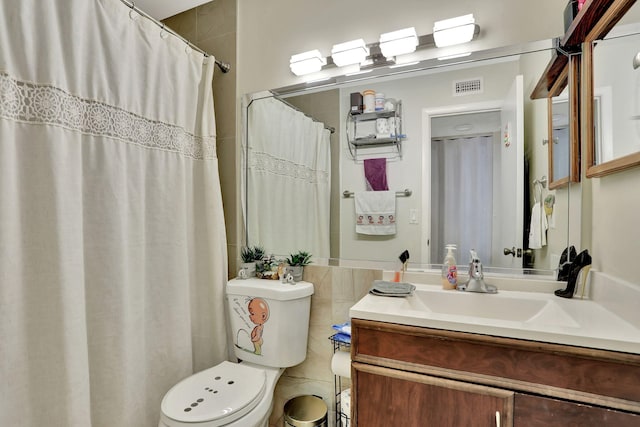 bathroom with curtained shower, visible vents, toilet, tile walls, and vanity