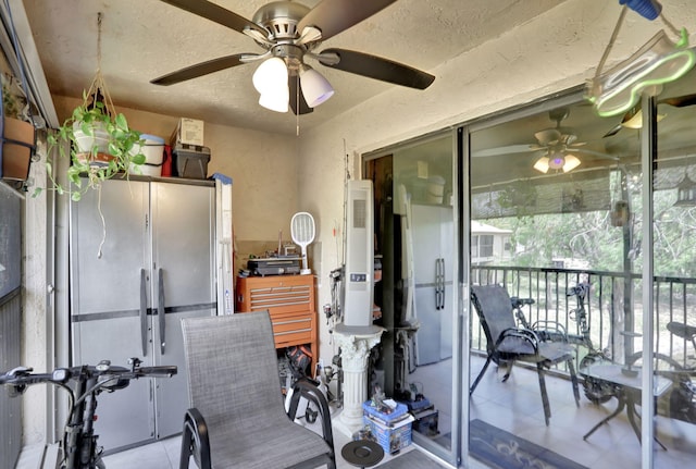 interior space featuring tile patterned flooring and a ceiling fan
