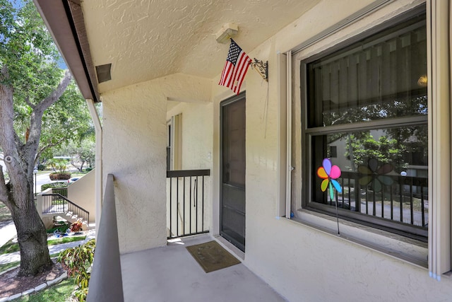 view of exterior entry featuring stucco siding