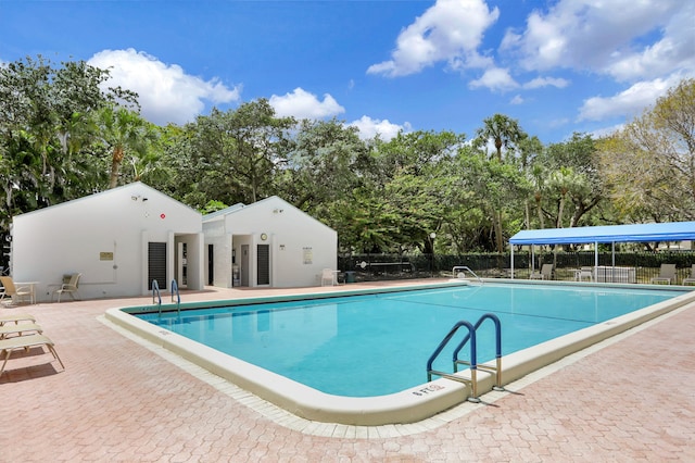 community pool featuring a patio and fence
