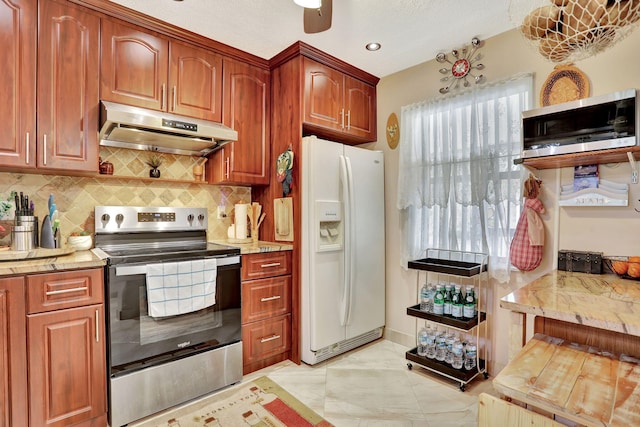 kitchen with light stone counters, stainless steel electric range oven, white fridge with ice dispenser, tasteful backsplash, and under cabinet range hood