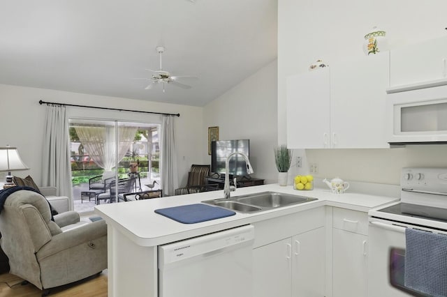1054 NW Tuscany Dr, Port Saint Lucie, FL 34986 - kitchen featuring a sink, open floor plan, a peninsula, white appliances, and lofted ceiling