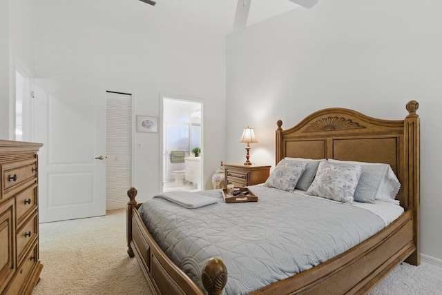 1054 NW Tuscany Dr, Port Saint Lucie, FL 34986 - bedroom featuring ensuite bathroom, a ceiling fan, a high ceiling, and light carpet