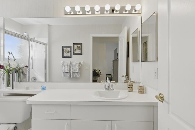 1054 NW Tuscany Dr, Port Saint Lucie, FL 34986 - bathroom featuring toilet, vanity, and a shower with door