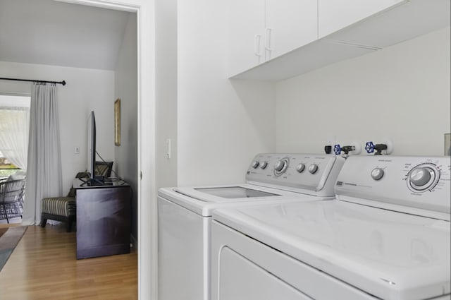 1054 NW Tuscany Dr, Port Saint Lucie, FL 34986 - clothes washing area featuring washer and dryer and light wood finished floors