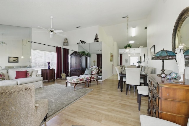 1054 NW Tuscany Dr, Port Saint Lucie, FL 34986 - living area featuring wood finished floors, a ceiling fan, and a high ceiling