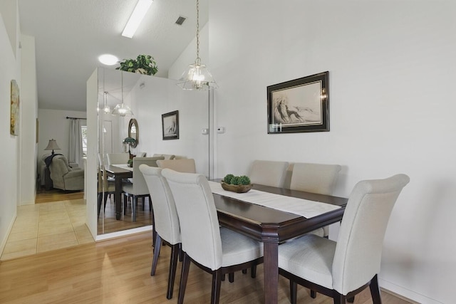 1054 NW Tuscany Dr, Port Saint Lucie, FL 34986 - dining room featuring visible vents, light wood-type flooring, baseboards, and high vaulted ceiling